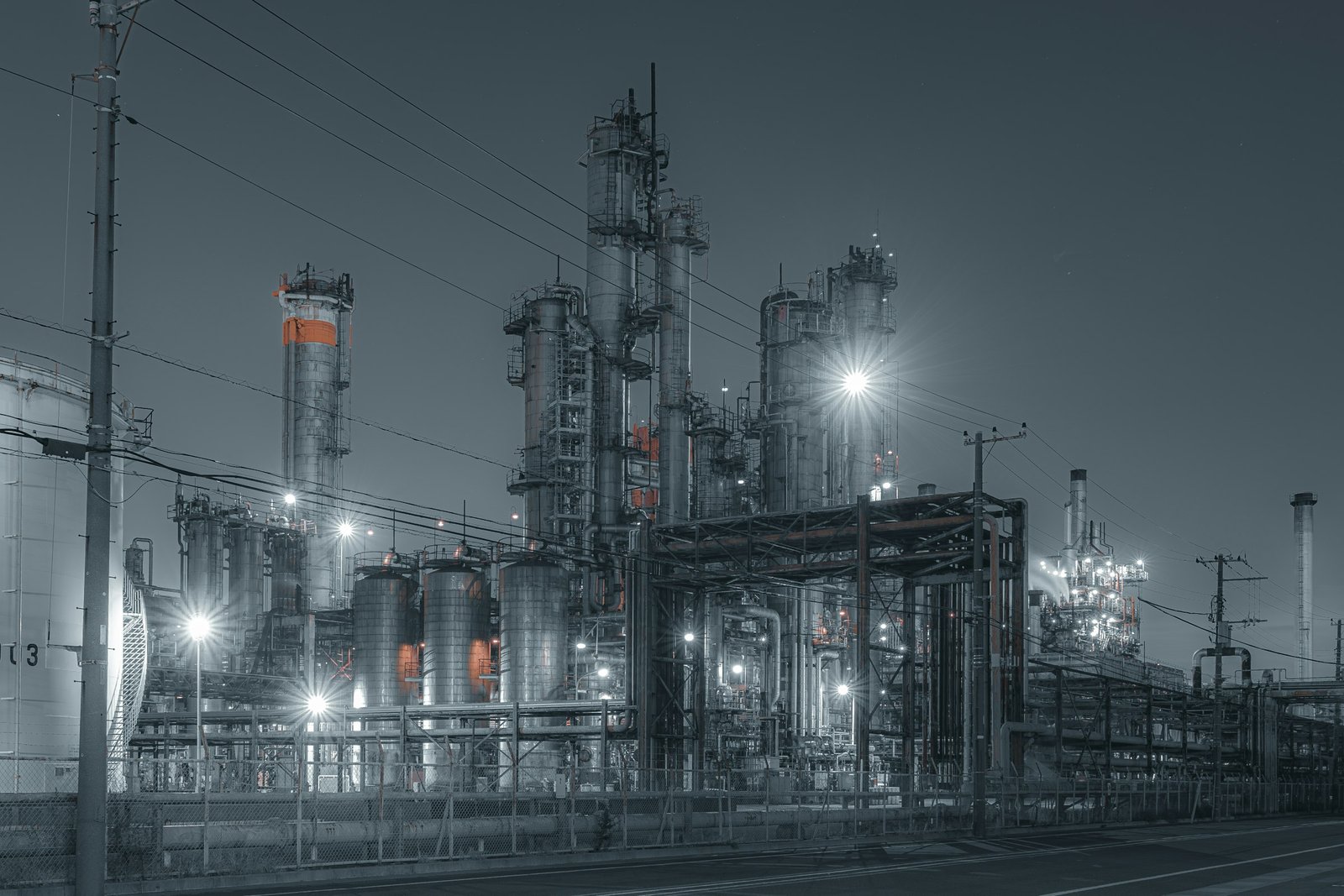 Industrial factory with lit processing units at night