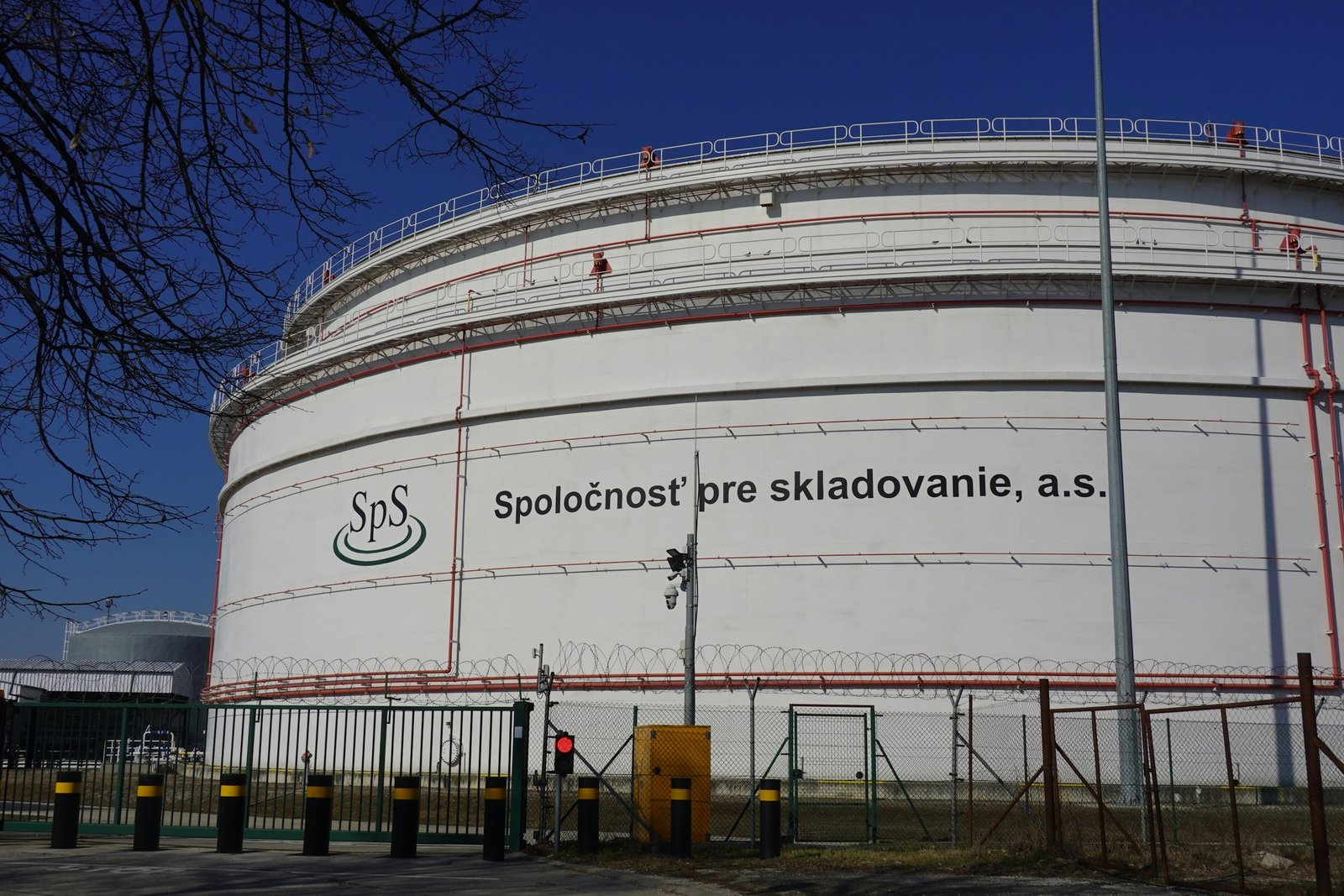 Large industrial storage tanks under a clear blue sky